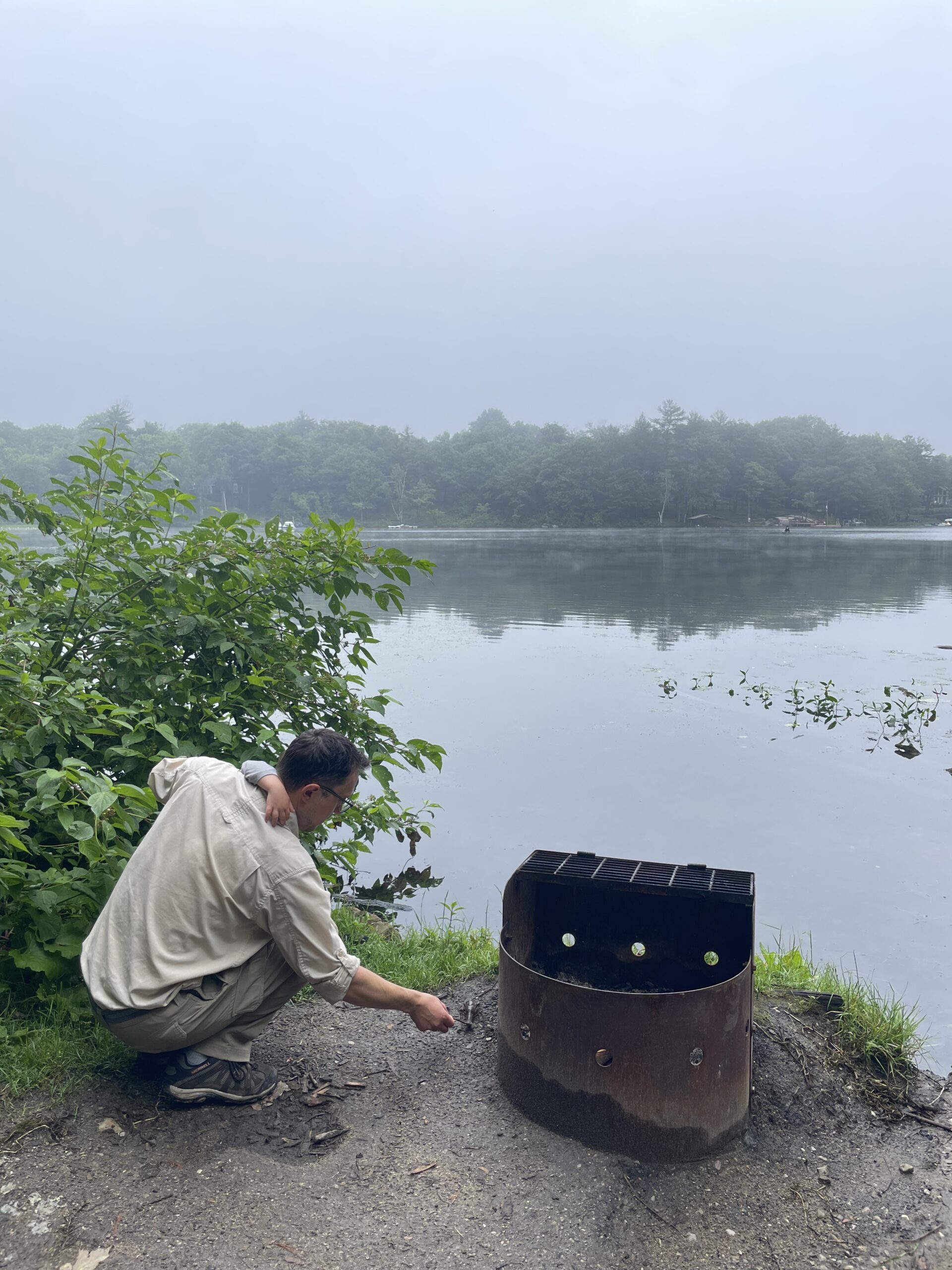 father and child exploring nature on campsite